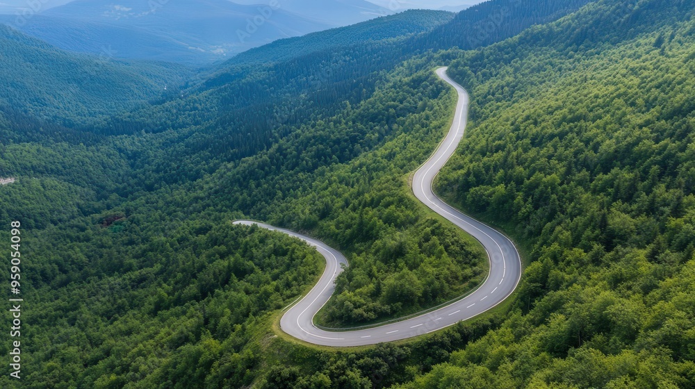 Aerial view of winding mountain road through forest Aerial view of winding mountain road through forest
