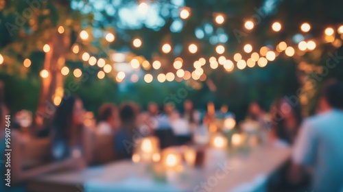 Blurred outdoor party with string lights and candlelit tables in a garden setting