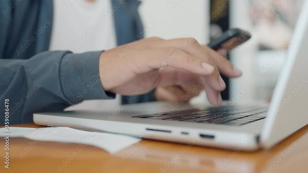 A person is typing on a laptop computer. The laptop is on a wooden table. The person is wearing a blue shirt A person is typing on a laptop computer. The laptop is on a wooden table. The person is wearing a blue shirt