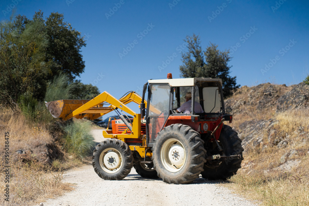 Tractor with front loader on country road Tractor with front loader on country road