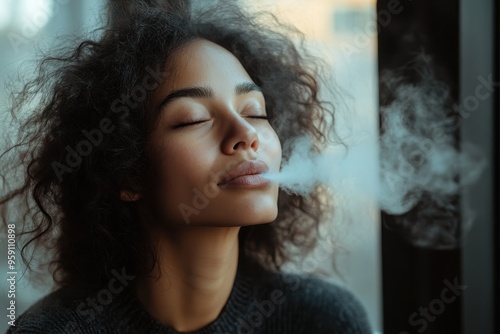 A woman sitting by a window, inhaling steam infused with eucalyptus, showcasing the traditional practice of steam inhalation for respiratory health. photo