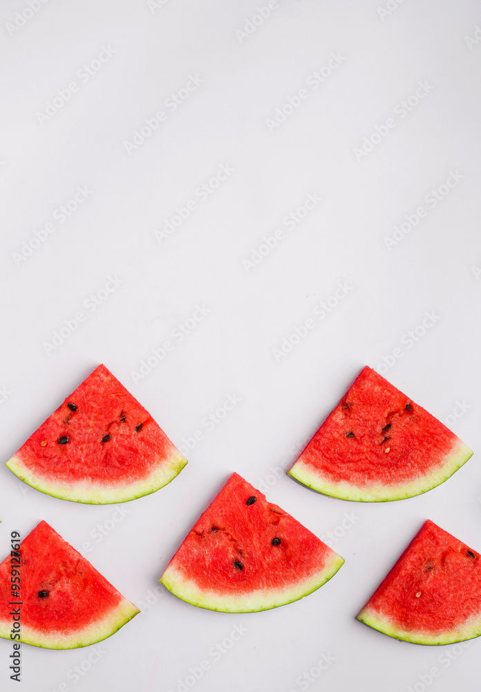 Fresh sliced red watermelon pieces on light background. top view. Fresh sliced red watermelon pieces on light background. top view.