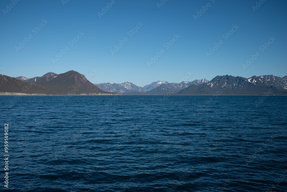 A bay surrounded by snow-capped mountains and dotted with ice formations. The magic of nature in its frozen splendor. A unique combination of ice and sea.Travel in cold weather, fresh air A bay surrounded by snow-capped mountains and dotted with ice formations. The magic of nature in its frozen splendor. A unique combination of ice and sea.Travel in cold weather, fresh air