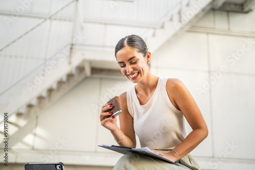young happy businesswoman sit outdoor and hold flask drink alcohol