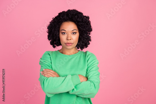 Photo of young charming woman with chevelure in green sweatshirt folded hands confident isolated on pink color background