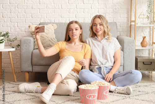 Two young women taking self...