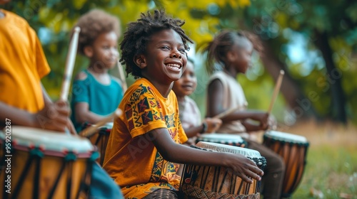 A group of children are sitting in a park, playing drums and smiling photo