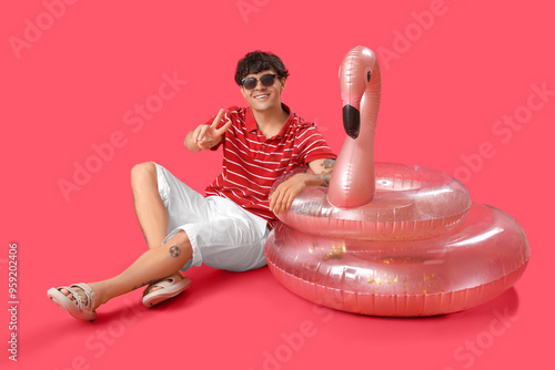 Young man with swim rings s...