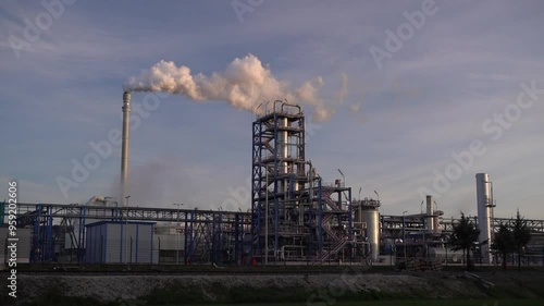 Wallpaper Mural Industrial factory chimney releasing thick smoke into the atmosphere at sunset. Ideal for projects focused on pollution, environmental issues, climate change, and industrialization. Torontodigital.ca