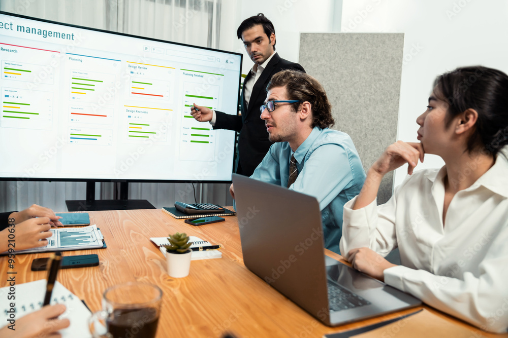 Project manager planning schedules for business task at meeting room, Gantt chart software show on TV screen. Multi ethnic diversity business people and modern business project management. Habiliment