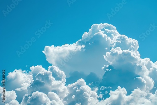 a blue sky with clouds and a plane flying in the sky cluster of fluffy clouds in a clear blue sky