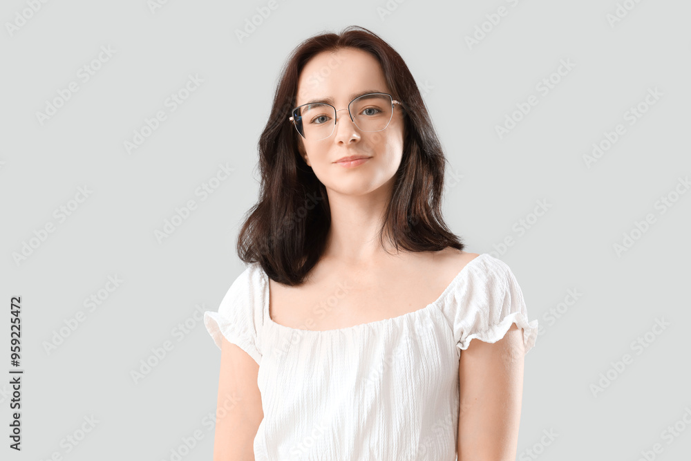 Young woman in eyeglasses on light background Young woman in eyeglasses on light background