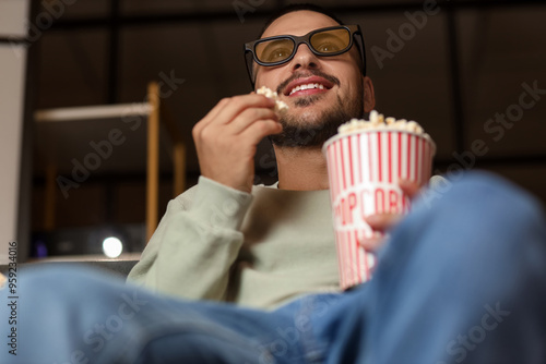 Young man with 3D glasses a...