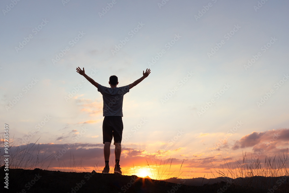 Person with arms outstretched at sunset, symbolizing gratitude and happiness. The serene scene evokes feelings of peace, freedom, and appreciation for life Person with arms outstretched at sunset, symbolizing gratitude and happiness. The serene scene evokes feelings of peace, freedom, and appreciation for life