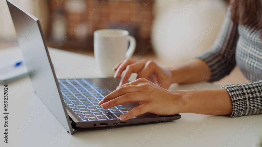 Teleworker writing emails on laptop, sending them to business partners. Employee working from home in bright stylish cozy apartment personal office, typing on notebook keyboard, camera B close up Teleworker writing emails on laptop, sending them to business partners. Employee working from home in bright stylish cozy apartment personal office, typing on notebook keyboard, camera B close up
