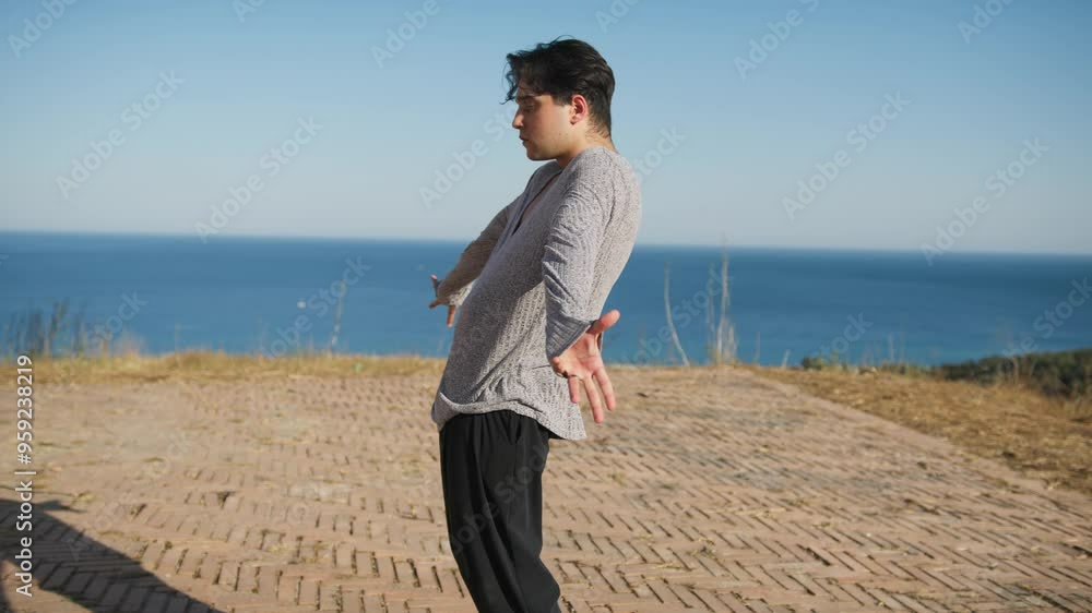 Latin American Dancer Man Moves Sinuously On Hill Near Ocean Latin American Dancer Man Moves Sinuously On Hill Near Ocean