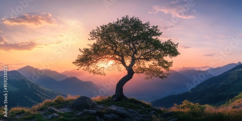 A serene landscape features a tree silhouette against a stunning sunset, framed by majestic mountains and lush fields, embodying natural beauty and offering peace to all who see it