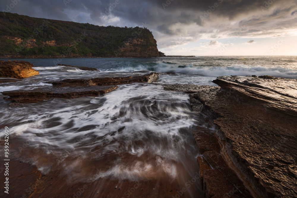 waves flowing over rocks at little beach on nsw central coast of australia during sunrise waves flowing over rocks at little beach on nsw central coast of australia during sunrise