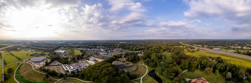 Obraz premium Aerial 180 degree panorama of Triodos bank in green park surrounding of Driebergen Zeist with train station and highway in the background