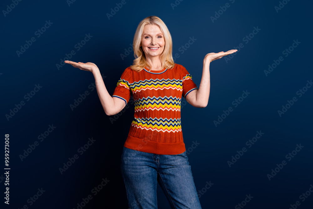 Photo of charming elderly woman wear stylish clothes hold empty space isolated on dark blue color background Photo of charming elderly woman wear stylish clothes hold empty space isolated on dark blue color background