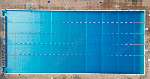 Photos Aerial drone shot looking straight down at an empty open air swimming pool