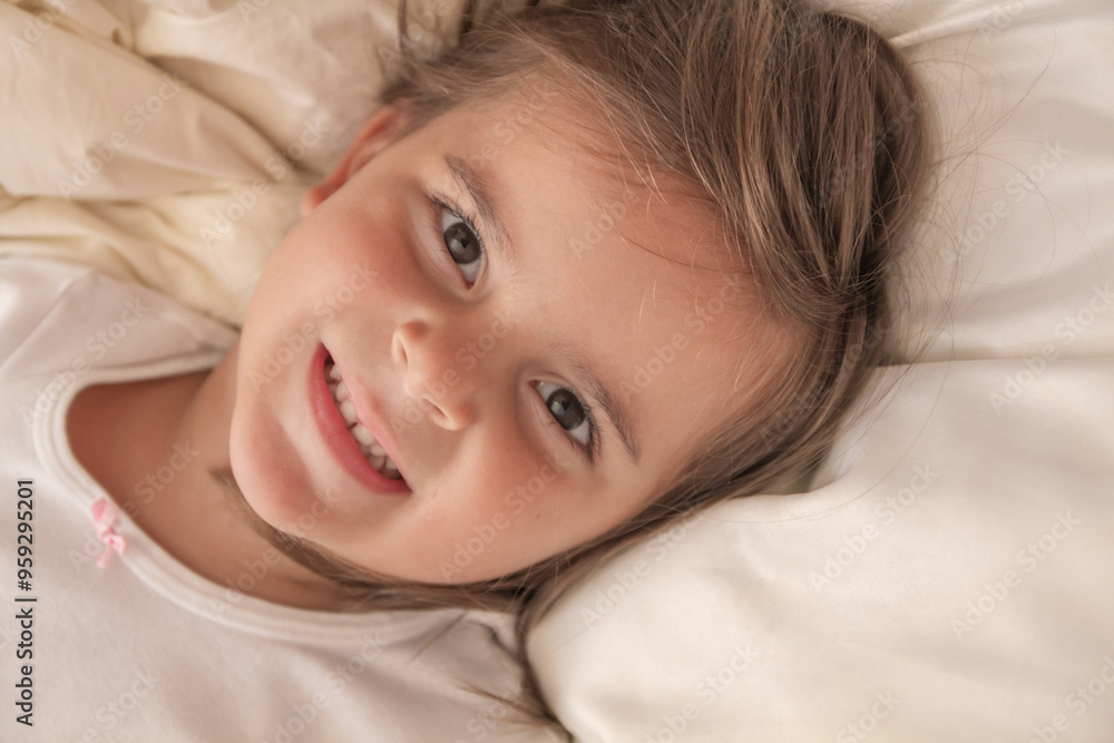 the little girl playing and tickling on the bed and having fun the little girl playing and tickling on the bed and having fun