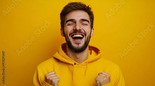 Portrait of a Happy Man in a Yellow Hoodie