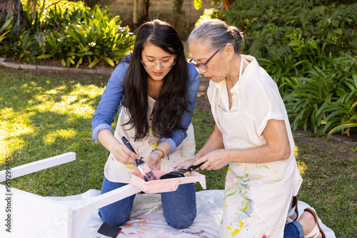 Painting and assembling furniture, asian granddaughter and grandmother bonding in diy project