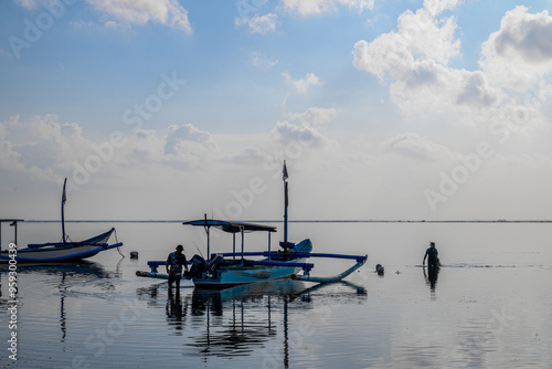 Sunrise on Bali Beach Boat and Fisherman  photo