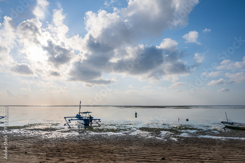 Sunrise on Bali Beach Boat and Fisherman  photo