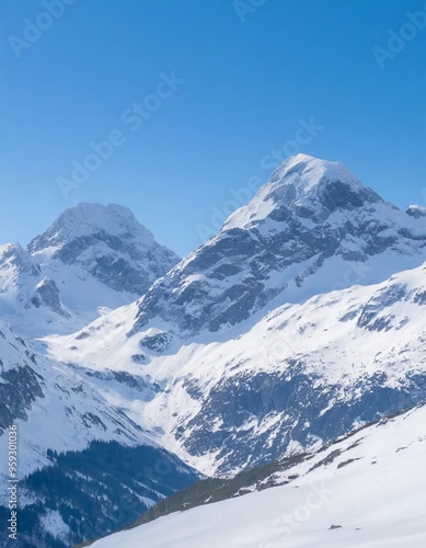 Majestic snow-capped mountain peaks under a clear blue sky in winter