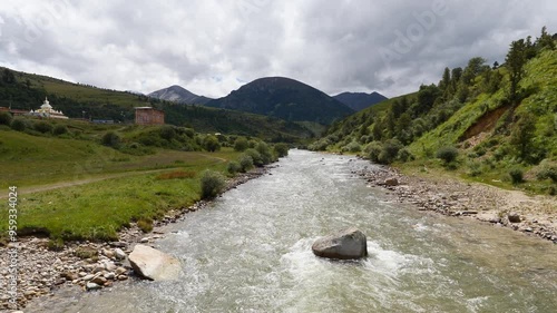 Flowing river stream through the mountains at Zeba village, genie, west of Sichuan, China, 4k slow motion footage. photo