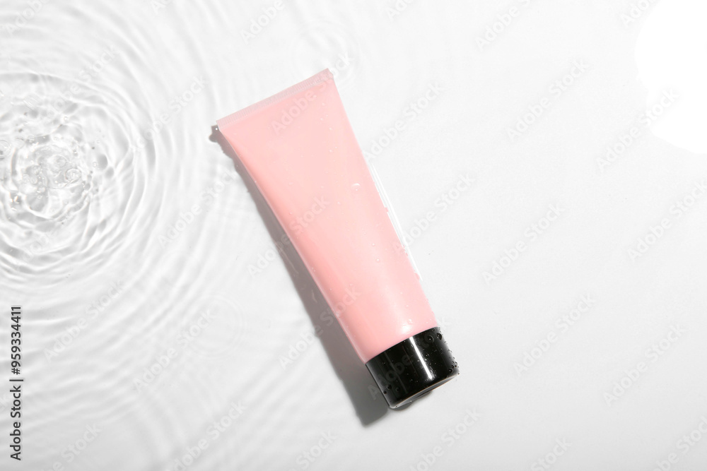 Cosmetic product. Tube with cream in water on light background, top view Cosmetic product. Tube with cream in water on light background, top view