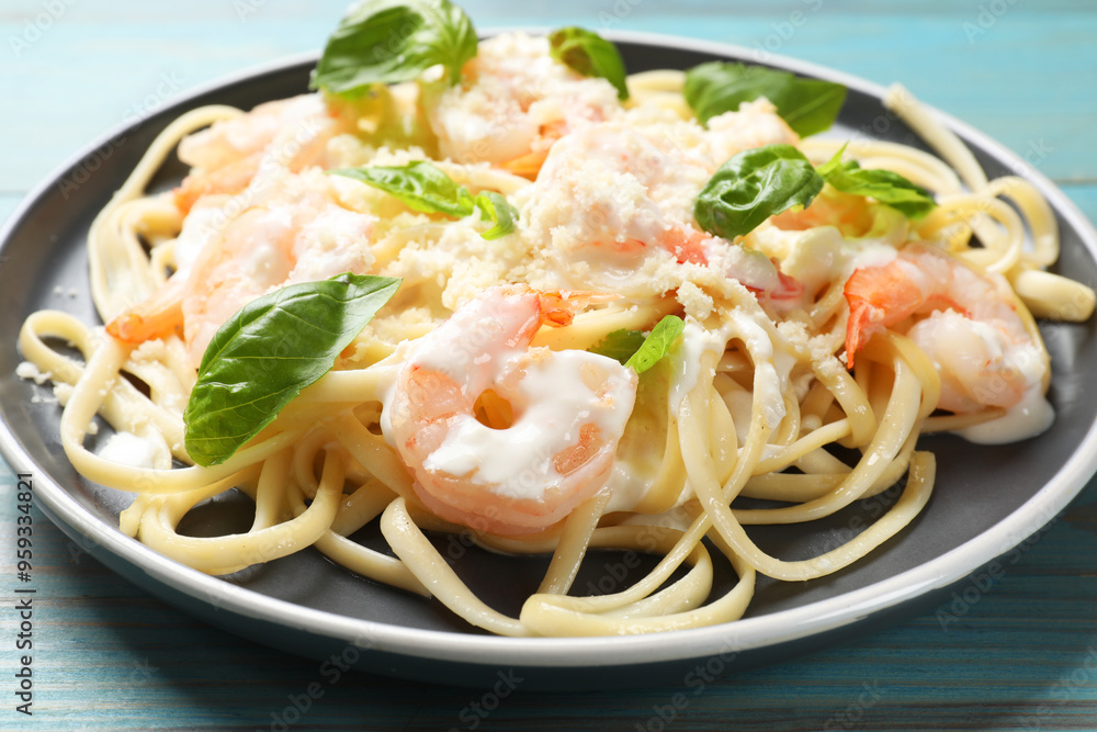 Tasty pasta with shrimps on light blue wooden table, closeup Tasty pasta with shrimps on light blue wooden table, closeup