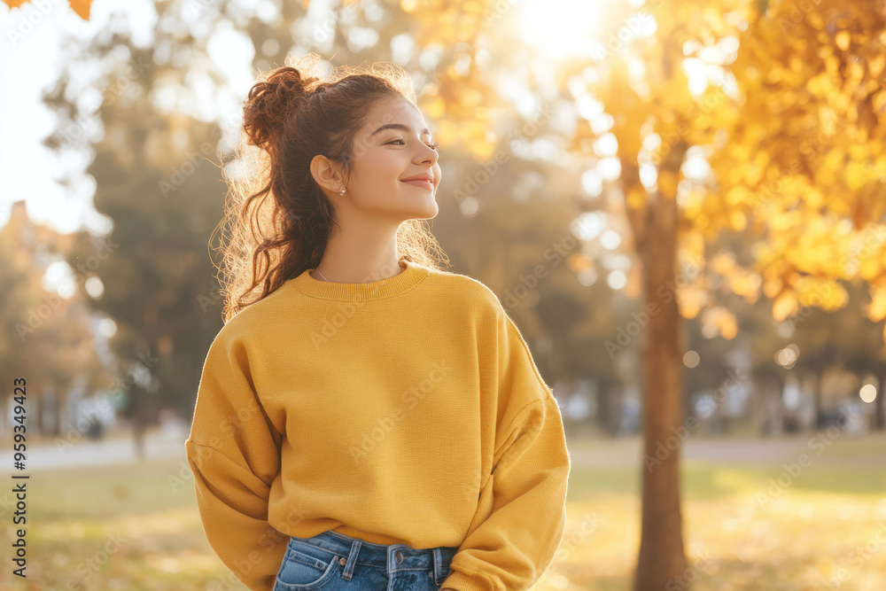 Hispanic woman wearing yellow knitted sweatshirt in autumn park at sunny day Hispanic woman wearing yellow knitted sweatshirt in autumn park at sunny day