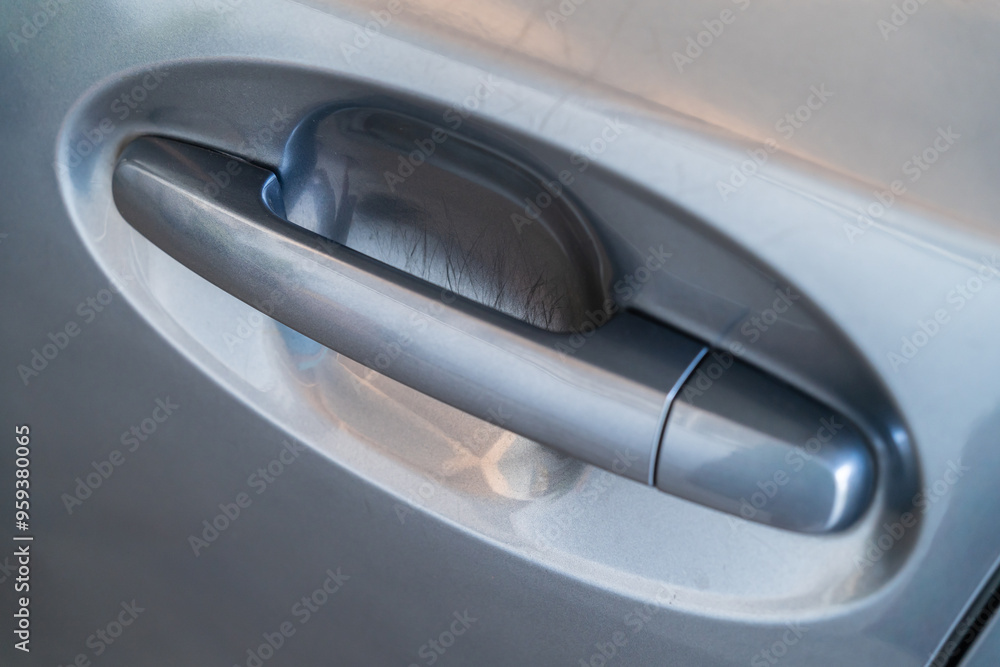 Close-up view of the scratches on the car door handle. Close-up view of the scratches on the car door handle.
