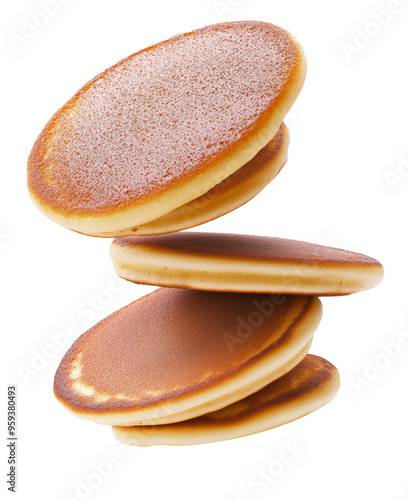 Pancakes flying close up on a white background.