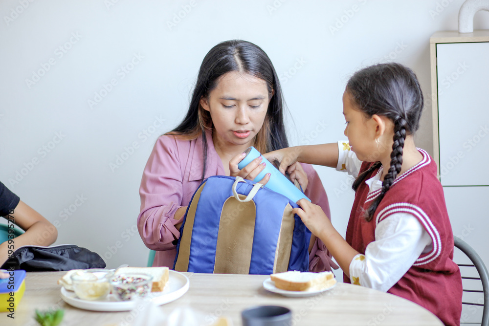 Asian Little Girl Preparing TO School With Putting Book On Backpack With Mother Asian Little Girl Preparing TO School With Putting Book On Backpack With Mother