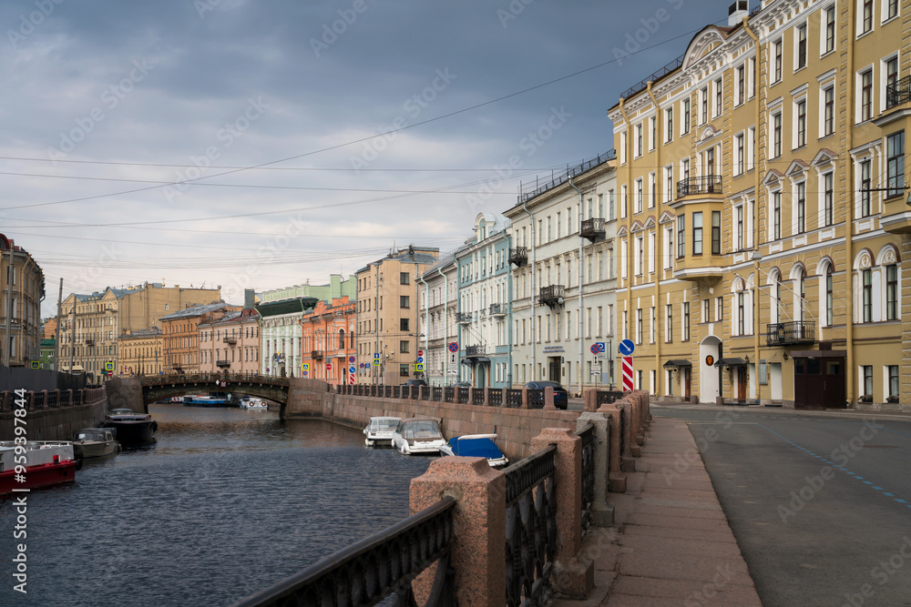 Obraz premium Moika River Embankment and Bolshoy Konyushenny Bridge on a cloudy spring morning, Saint Petersburg, Russia