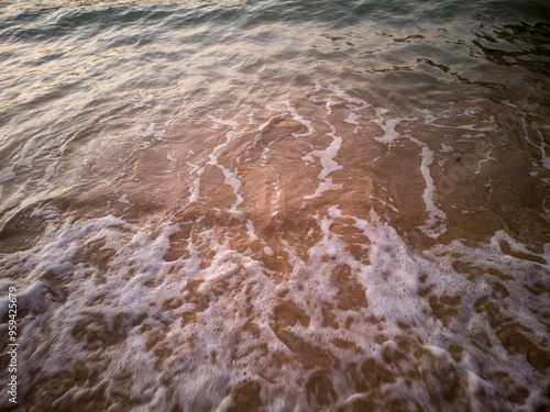 Nature background image of foamy wave on sand