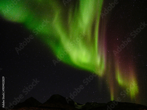 Northern Lights over Angmagssalik Fjord near settlement Kuummiit (formerly spelled Kummiut). Ammassalik area in East Greenland, Danish Territory. photo