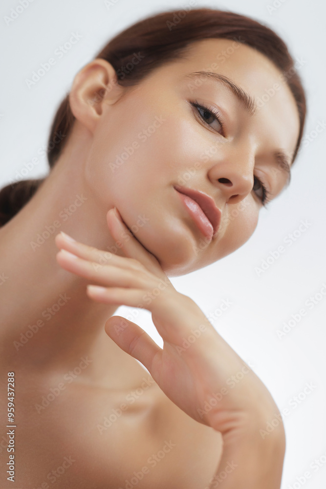 Young Woman with Flawless Skin Touching Chin in Minimalist Beauty Portrait Young Woman with Flawless Skin Touching Chin in Minimalist Beauty Portrait