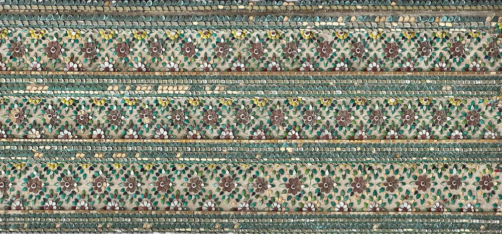 Close up of Thailand temple engraving and mural art pattern on wall, in different shapes, forms, and carved in every details, in various paint colors. Seamless background texture. Close up of Thailand temple engraving and mural art pattern on wall, in different shapes, forms, and carved in every details, in various paint colors. Seamless background texture.