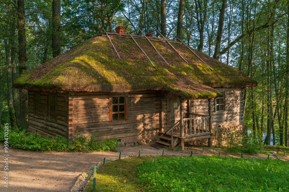 Traditional Russian log bathhouse in the Trigorskoye Estate of the Pushkin Natural Landscape Museum-Reserve on a sunny summer day, Pushkinskiye Gory, Pskov Region, Russia Traditional Russian log bathhouse in the Trigorskoye Estate of the Pushkin Natural Landscape Museum-Reserve on a sunny summer day, Pushkinskiye Gory, Pskov Region, Russia