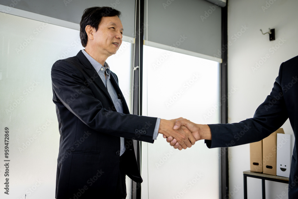 Handshake of two businessmen who enters into the contract to develop a new software to improve business service at a company.
Handshake of two businessmen who enters into the contract to develop a new software to improve business service at a company.