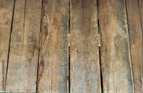 Close up of rustic rough solid wood decking panel, weathered and decayed solid wood decking.