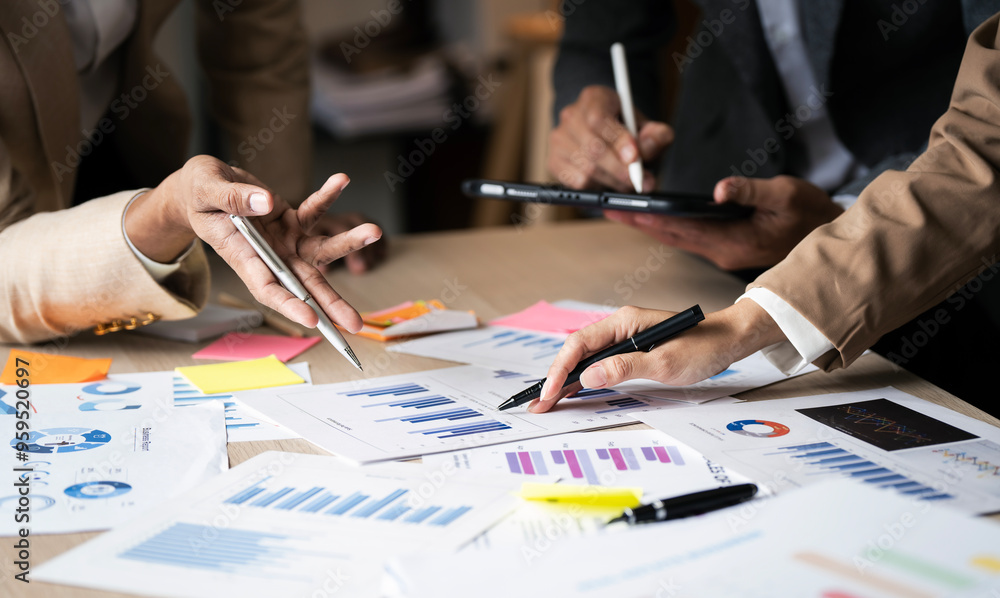 Business people co working, group of business people point to graphs and charts to analyze market data, balance sheet, account Business people co working, group of business people point to graphs and charts to analyze market data, balance sheet, account
