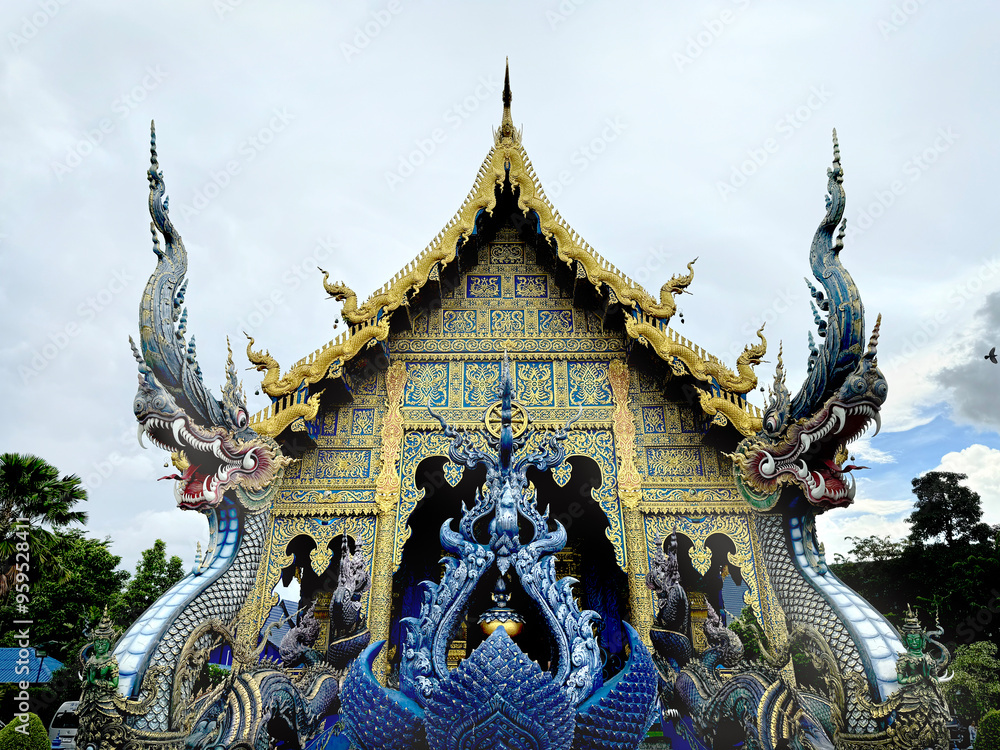 Fototapeta premium The famous Blue temple at Chiang Rai, Thailand, or Wat Rong Suea Ten in Thai. This temple hosts many Buddhist ornaments painted in all blue and gold colors.