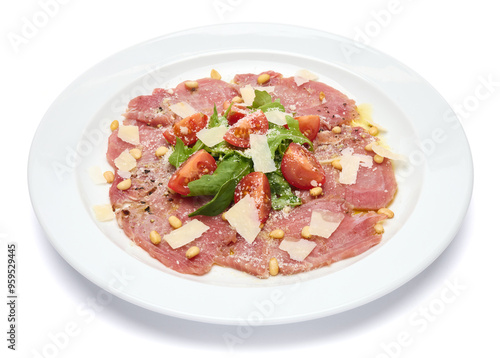 cooking tuna carpaccio - cherry tomato pieces on a plate with raw tuna fillet slices