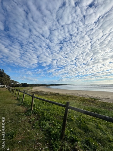 Ocean views, jetty lifestyle, beach lifestyle, clouds, coastal scenery, seaside living, shoreline views, oceanfront relaxation, beachside adventures, jetty walks, beach sunsets, maritime atmosphere, 